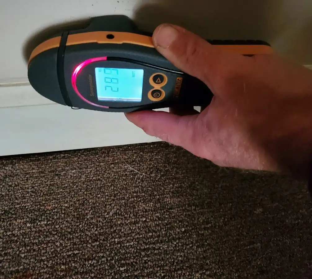 Moisture detection at baseboard during Storm Damage Restoration in Pampa